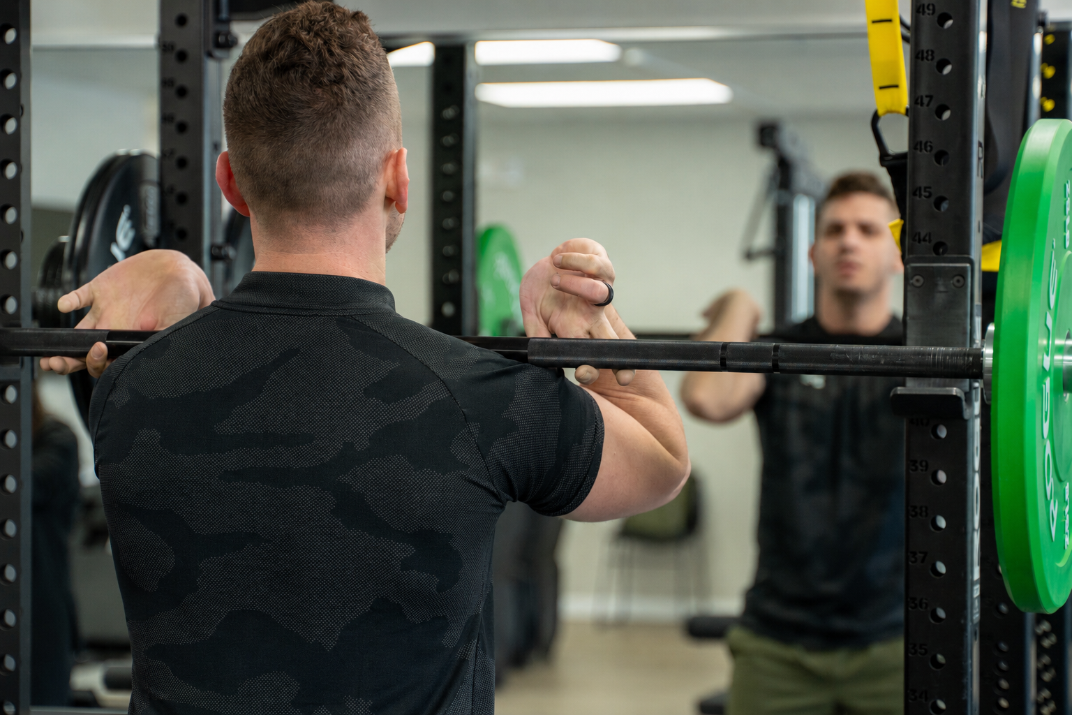 EVO coach front squatting in the rack